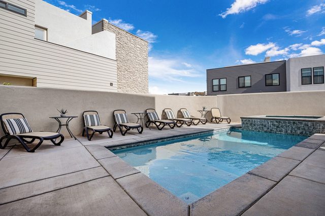 Private pool with row of lounge chairs and spa