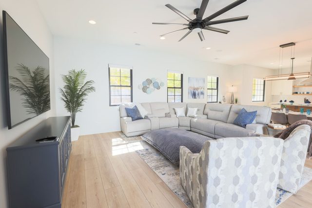 Open family room seating flowing into kitchen and dining