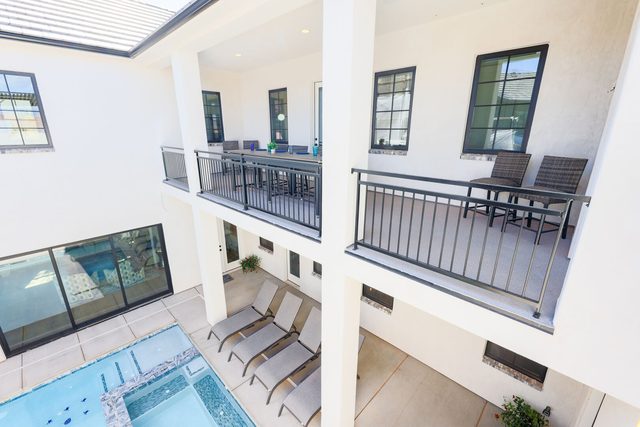 Courtyard pool and loungers viewed from the upper balcony