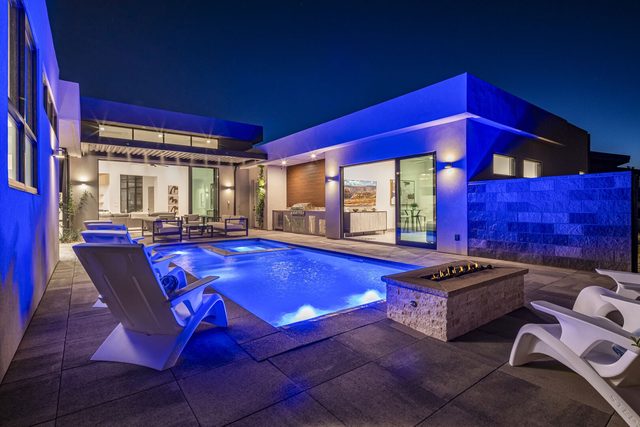 Private pool and fire pit lit blue at night at Copper Rock 3557