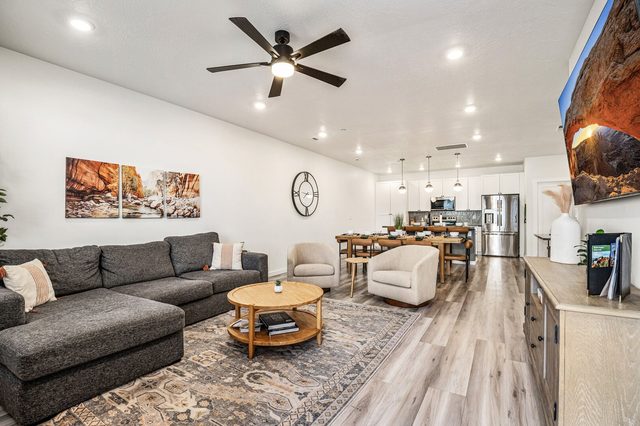 Open living room with sectional sofa and dining area beyond