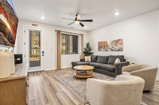 Living room with patio door, sectional sofa and accent chairs