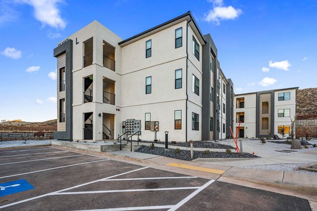 Three-story condo building and parking lot at Coral Canyon at Terra West L-201