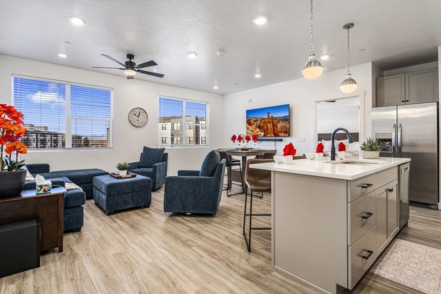 Open kitchen island with bar stools next to the living room