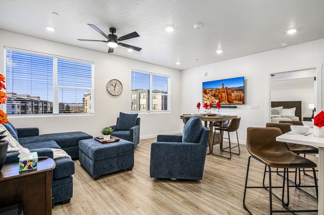 Open living area with blue sectional and dining bar at Coral Canyon at Terra West L-201