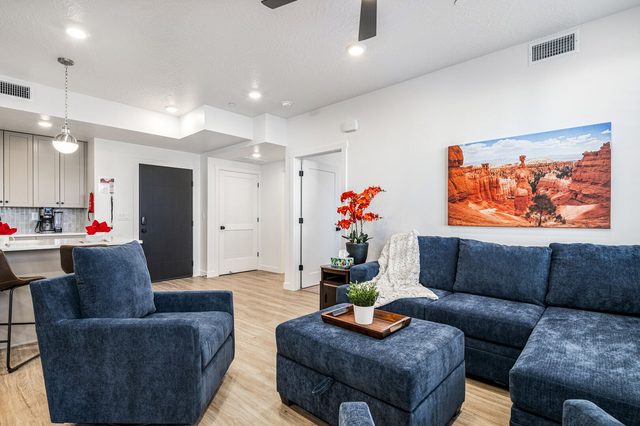 Living room seating with sectional and view toward the kitchen