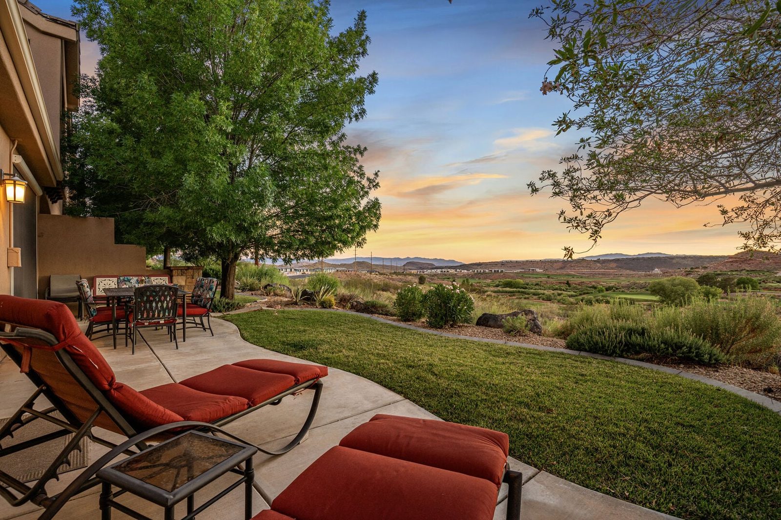Back patio loungers overlooking the golf course at sunset at Pointe of View