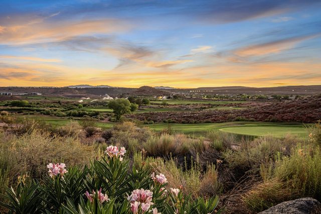 Coral Canyon golf course fairway and desert brush at sunset behind the home