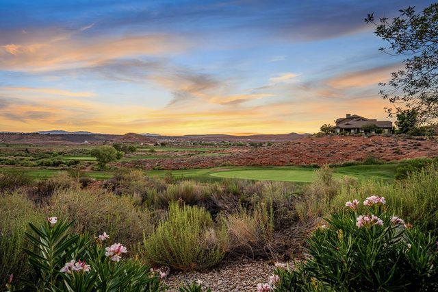 Coral Canyon fairway and green framed by desert flowers at sunset