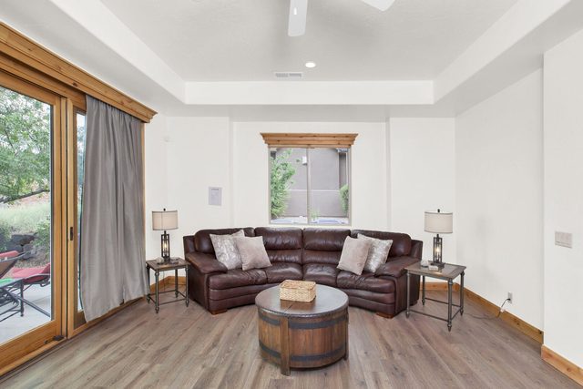 Leather sectional and barrel coffee table in the bright living room