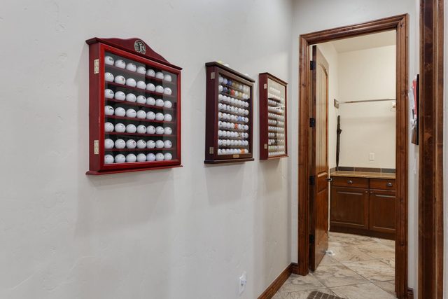 Hallway golf ball display cases outside the bathroom