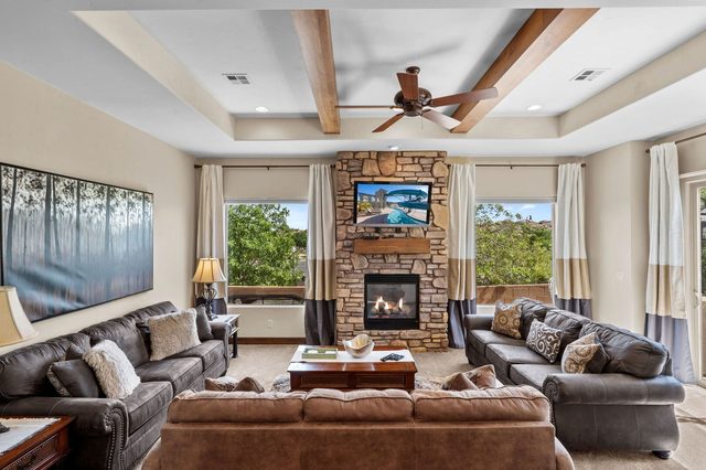 Living room with beamed ceiling, fireplace and leather sofas