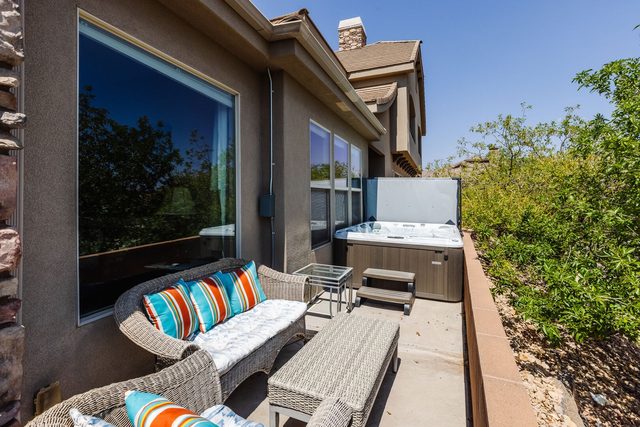 Private hot tub and wicker lounge on the patio at Coral Ridge 1924