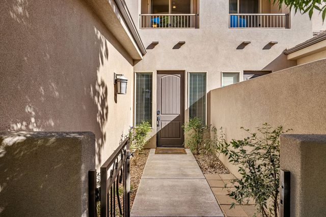 Gated front courtyard walkway leading to the entry door