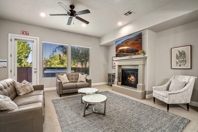 Family room with gas fireplace, leather sofas and wall TV at Coral Ridge 1998