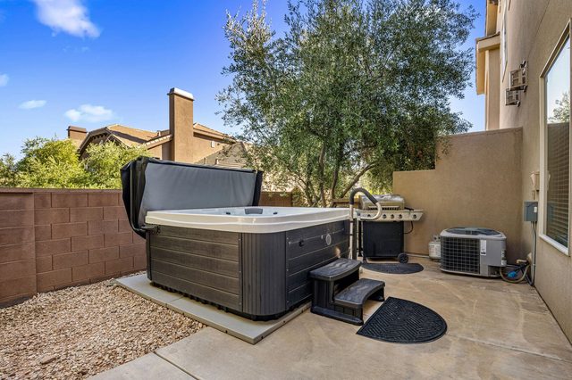 Covered private hot tub with steps and nearby grill