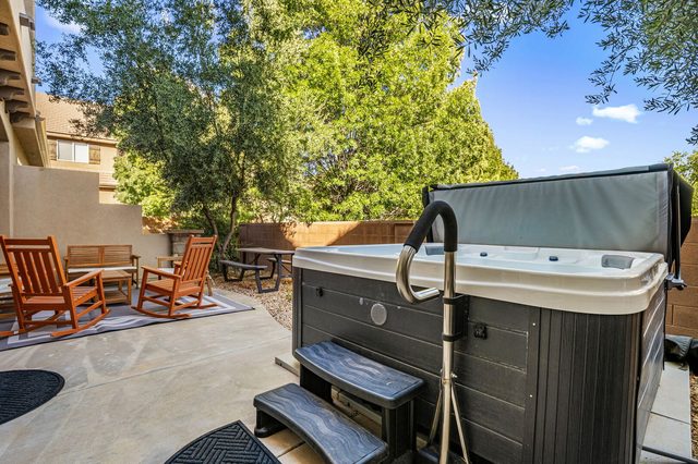 Private hot tub with handrail and patio seating