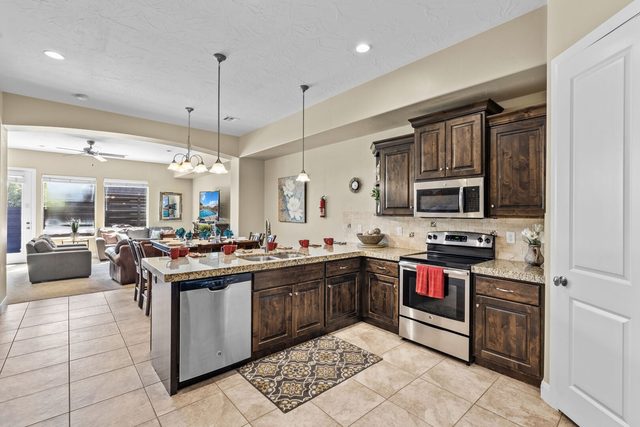 Kitchen with granite counters, stainless appliances and breakfast bar at Coral Ridge 2065