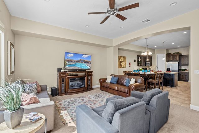 Open living room with fireplace flowing into dining area at Coral Ridge 2065