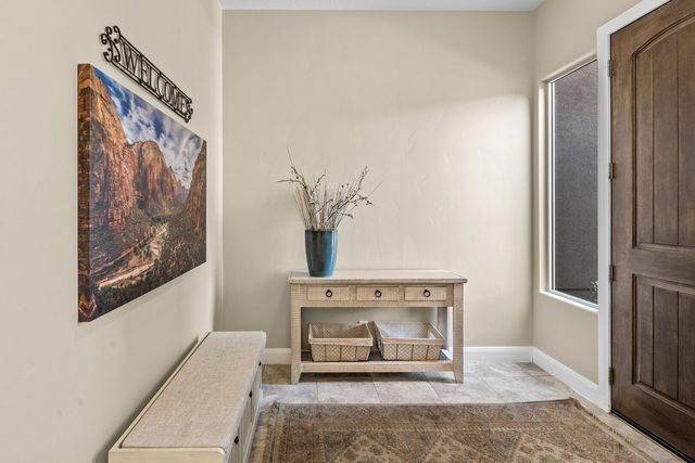 Entry foyer with bench, console table and red rock artwork
