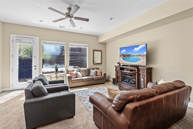 Living room with leather sofas, fireplace and patio door