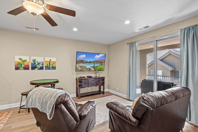 Upstairs loft lounge with recliners, game table and balcony at Coral Ridge 2065