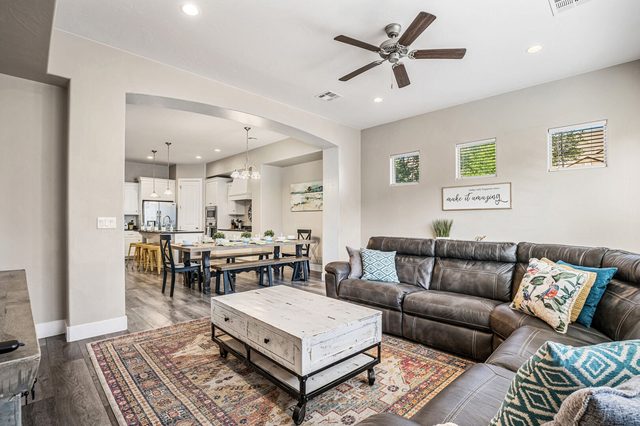 Great room with leather sectional open to dining and kitchen at Coral Ridge 2076