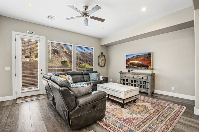 Family room with leather recliner sectional and smart TV