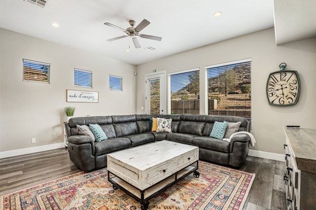 Great room sectional with red rock hillside through windows