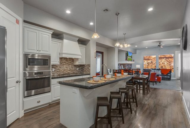 Kitchen island with bar stools and double wall ovens