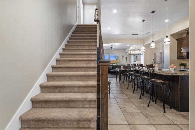 Entry staircase beside the kitchen bar seating at Coral Ridge 2087