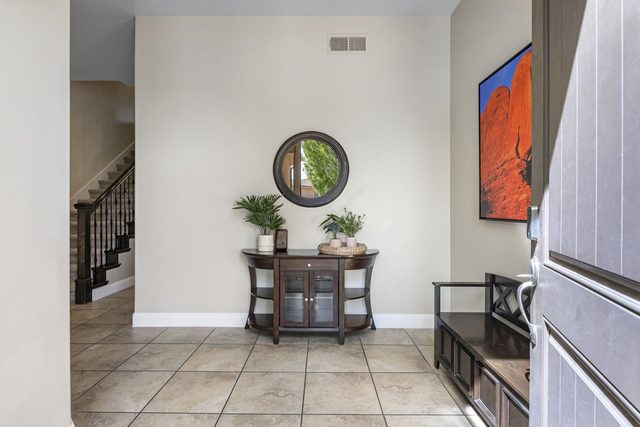 Entry foyer with console table and staircase at Coral Ridge 2087
