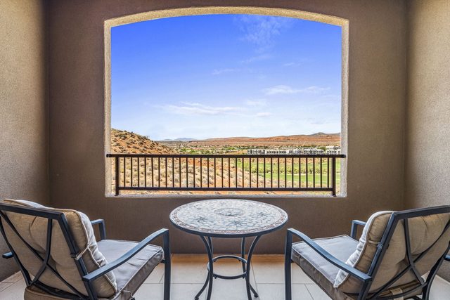 Golf course view framed by the balcony arch at Coral Ridge 2087