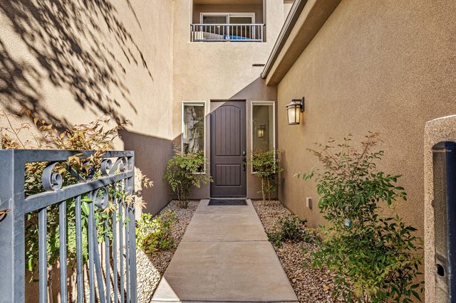 Gated front courtyard walkway leading to the entry door