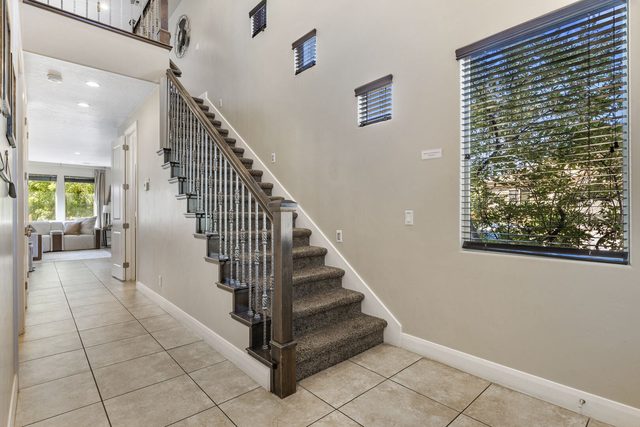 Entry hallway with staircase and tile floors