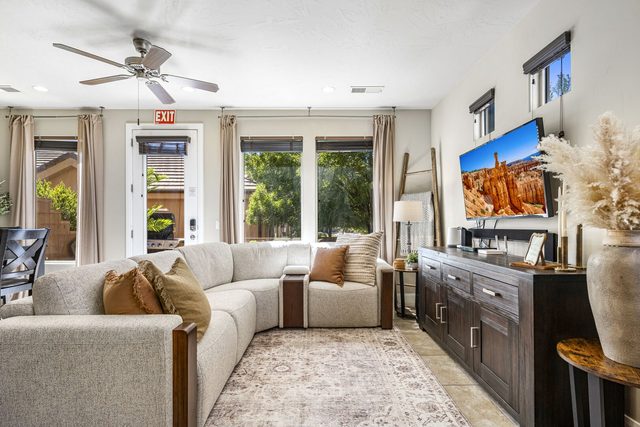 Living room with sectional sofa and wall-mounted TV at Coral Ridge 4144