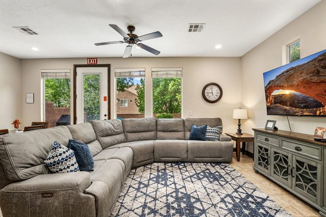 Living room with reclining sectional and smart TV at Coral Ridge 4174