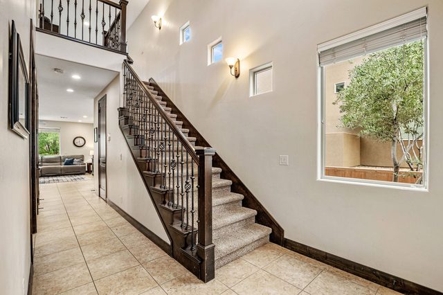 Entry hall with iron-rail staircase and tile floors