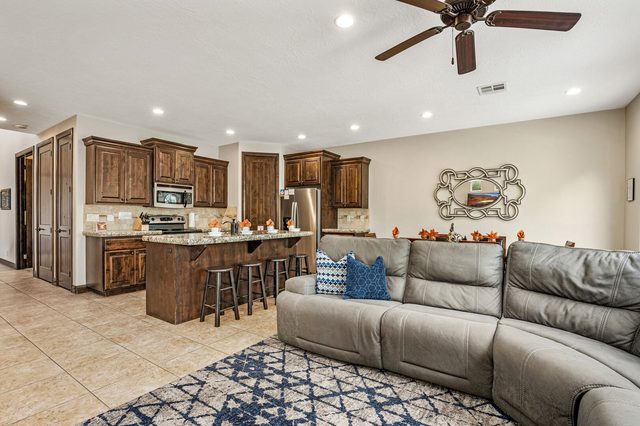 Living room sectional facing the open kitchen and bar stools
