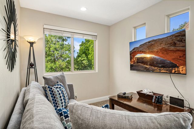 Loft seating area with sofa and wall-mounted smart TV