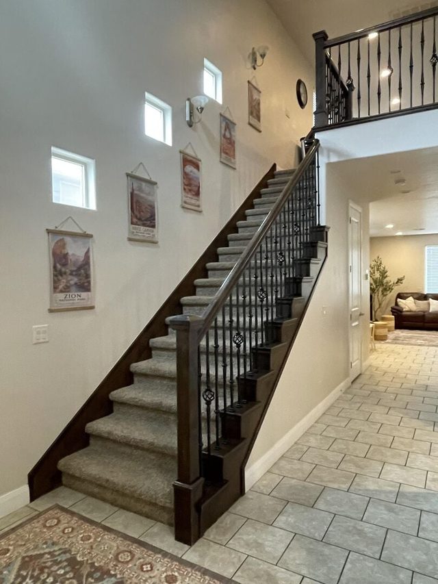 Staircase with iron railing leading to the upstairs loft