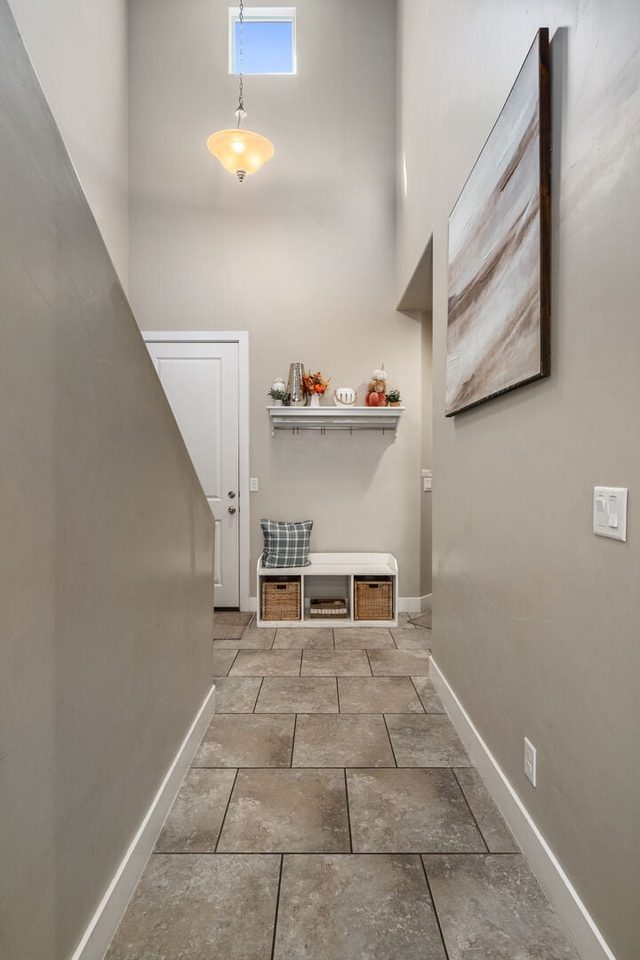Tiled entry hallway with bench and cubby storage