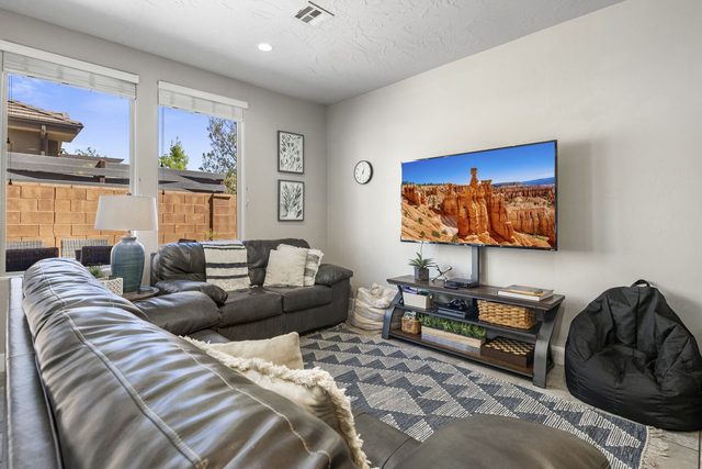 Leather sectional facing a large TV in the living room
