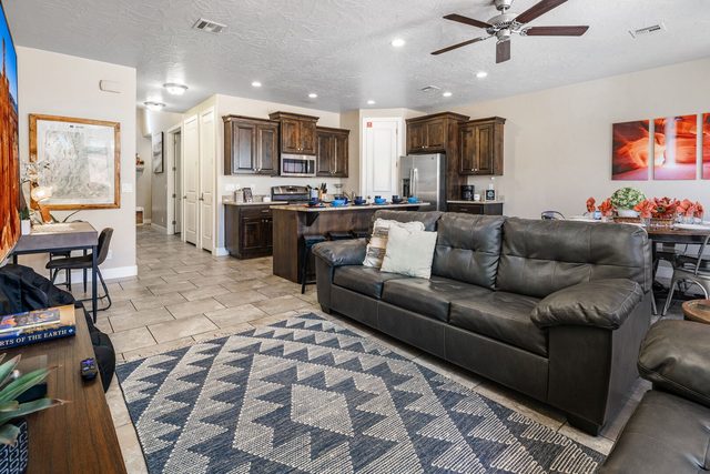 Open living room with sofa looking toward the kitchen