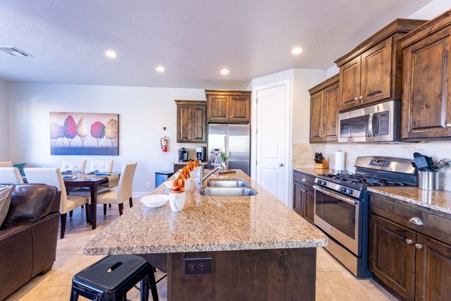 Kitchen island with granite counters and stainless appliances