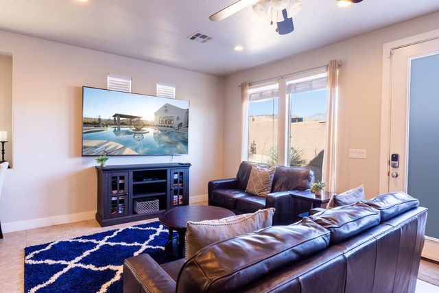 Family room with leather sofas and wall-mounted smart TV
