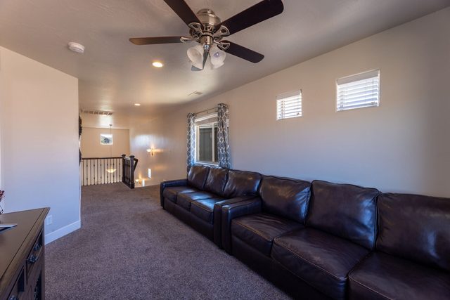 Loft seating area with leather sofas near the stair railing