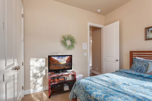 Queen bedroom with small TV stand and closet
