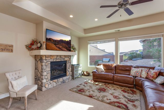 Living room with leather sectional and stone fireplace at Coral Ridge 4246
