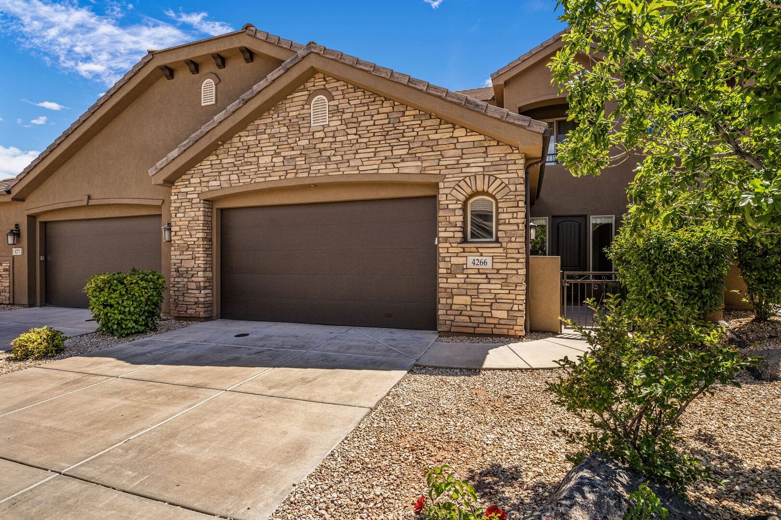 Front of Coral Ridge 4266 with stone facade and two-car garage